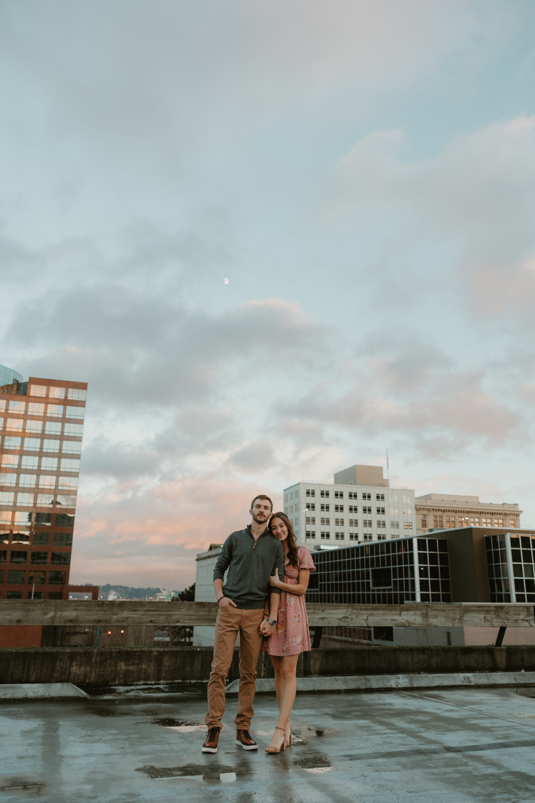 couple linking arms on a parking garage in tacoma