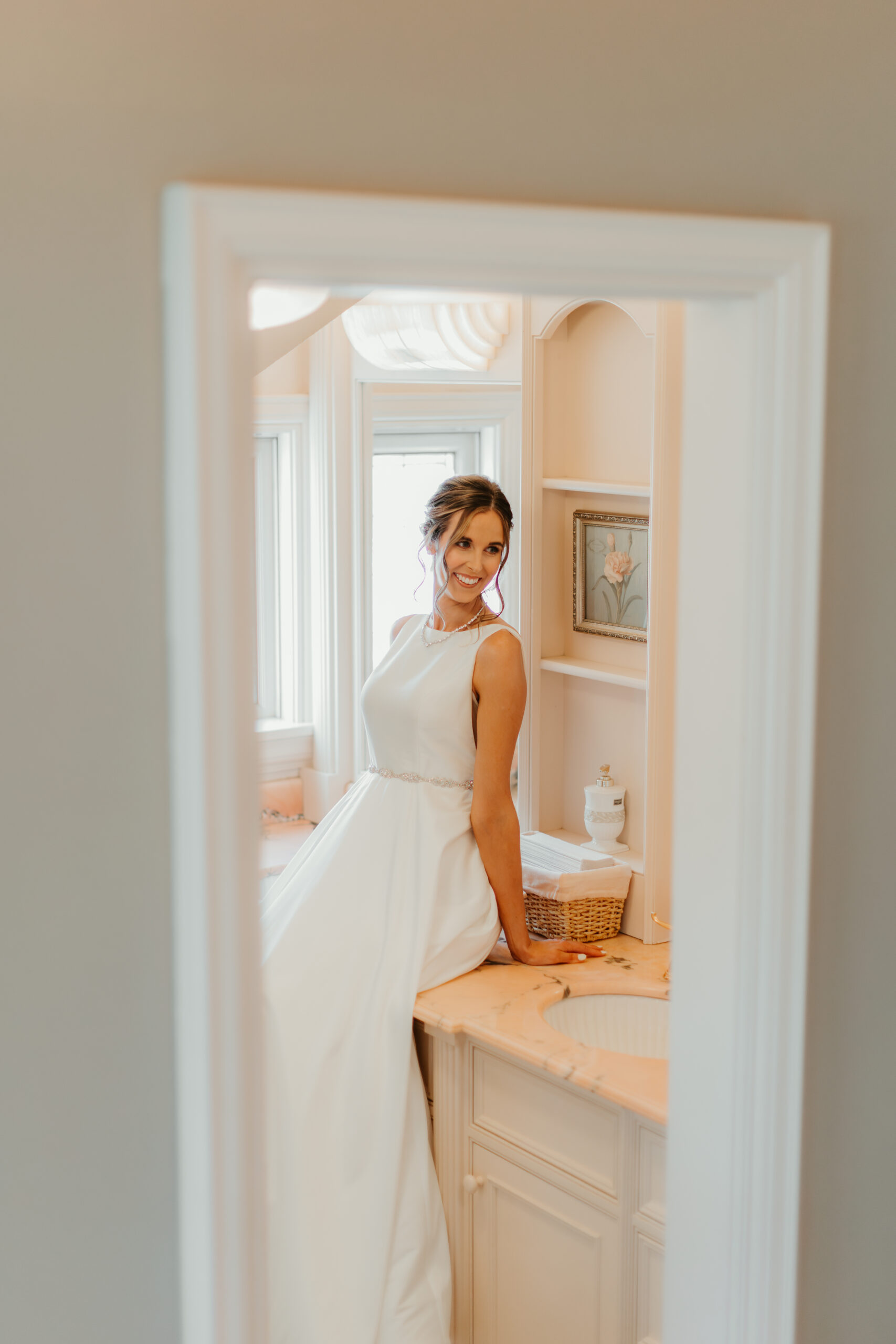 bride sitting on a vanity 