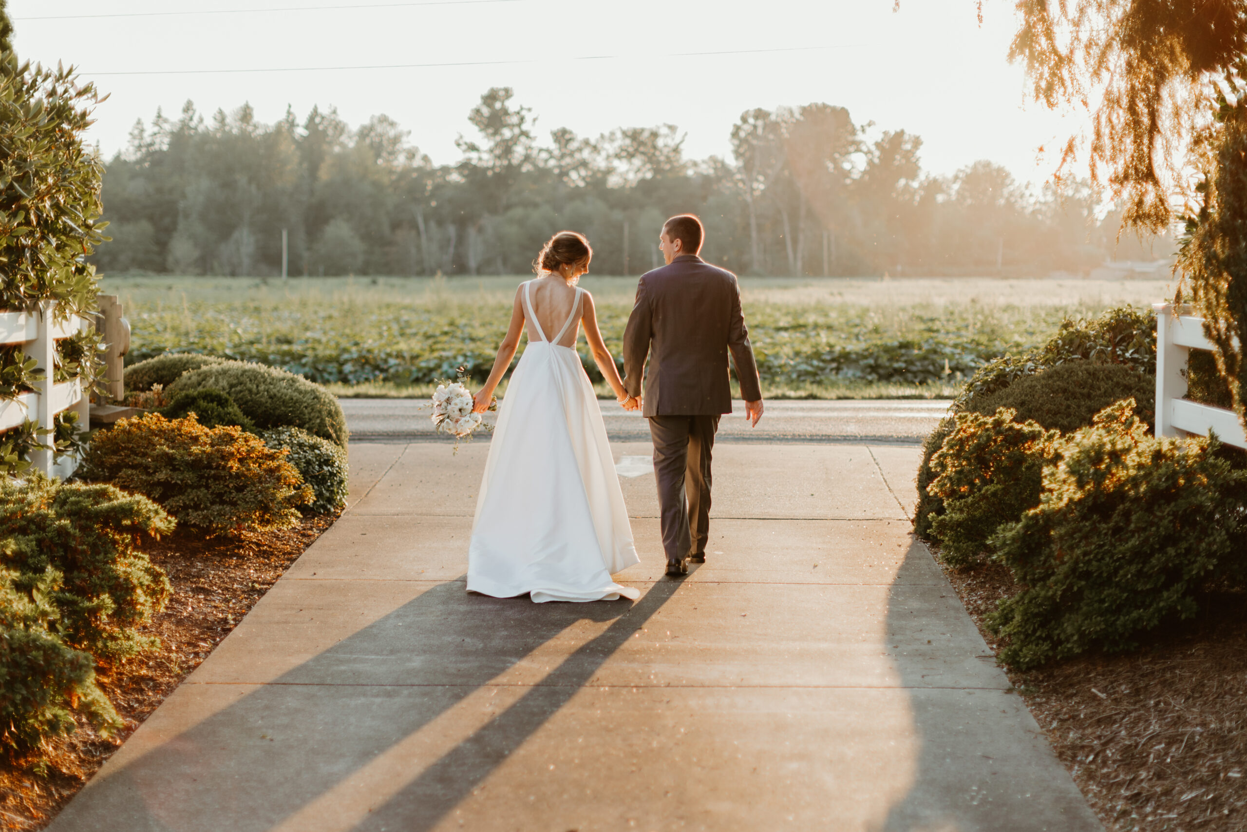 bride and groom walking during sunset at laurel creek manor