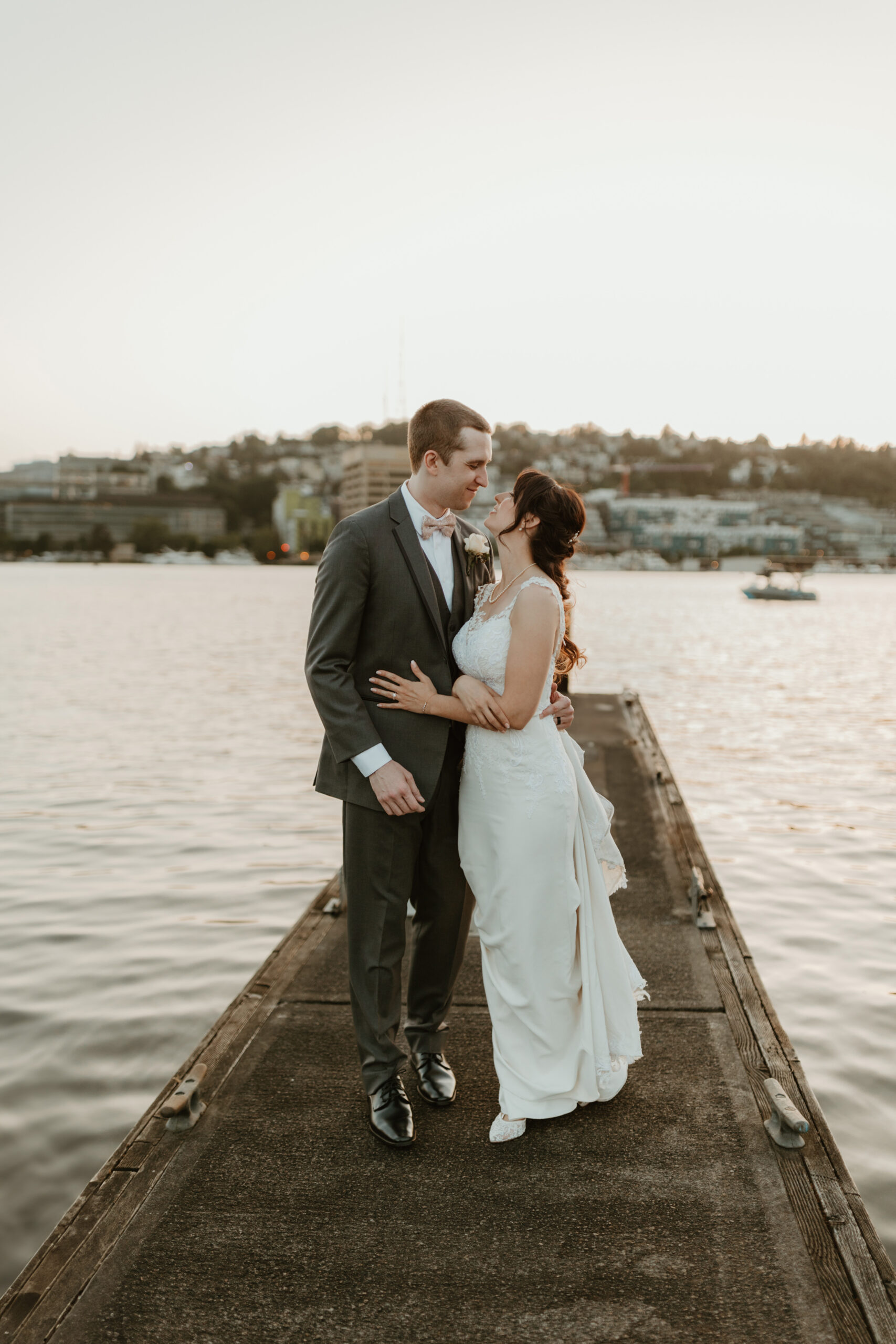 bride and groom hugging on a dock