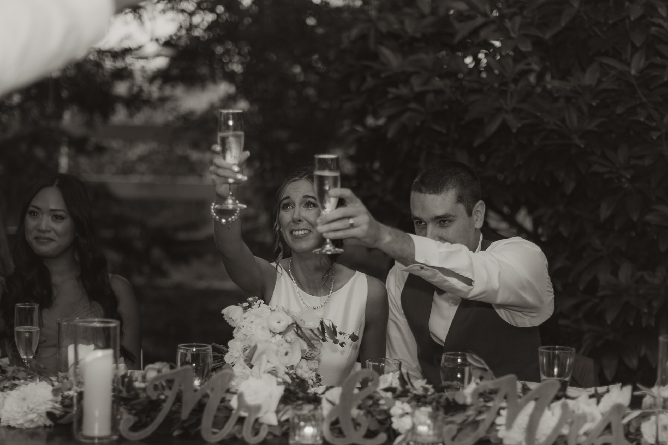 bride and groom raising their glasses for a toast