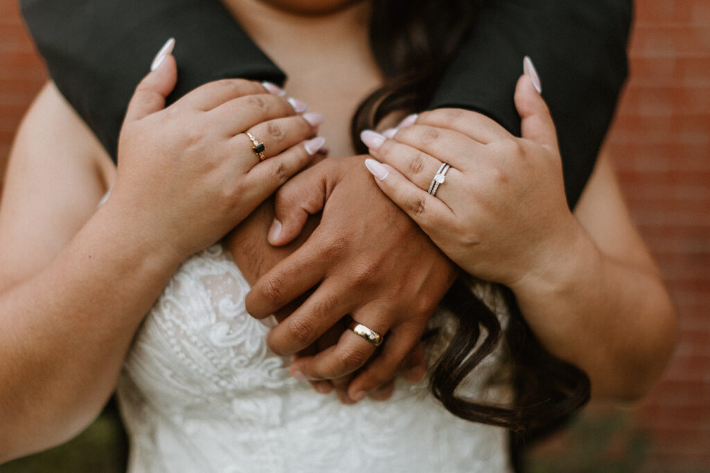 bride and groom showing their wedding rings