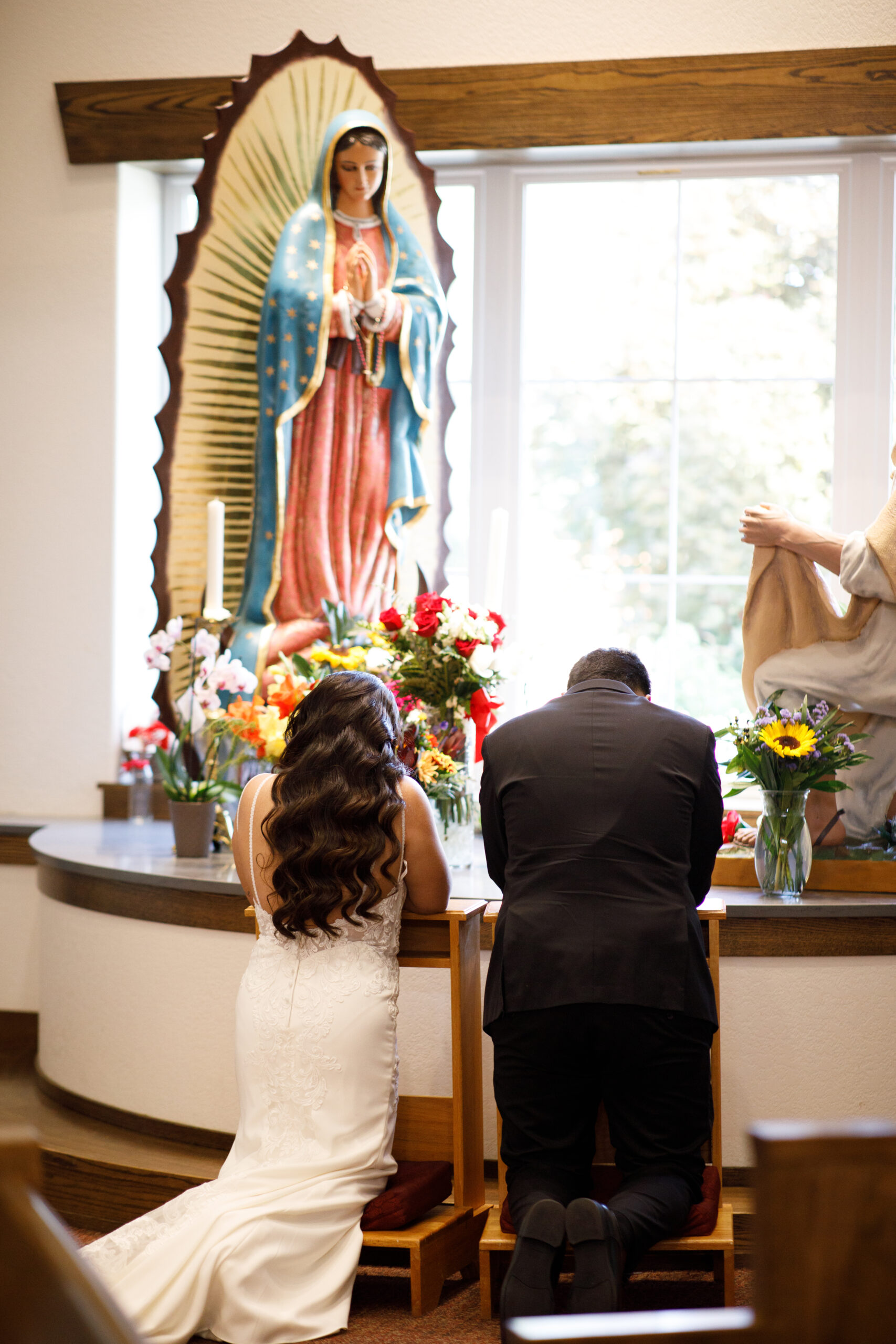 bride and groom praying on their wedding day