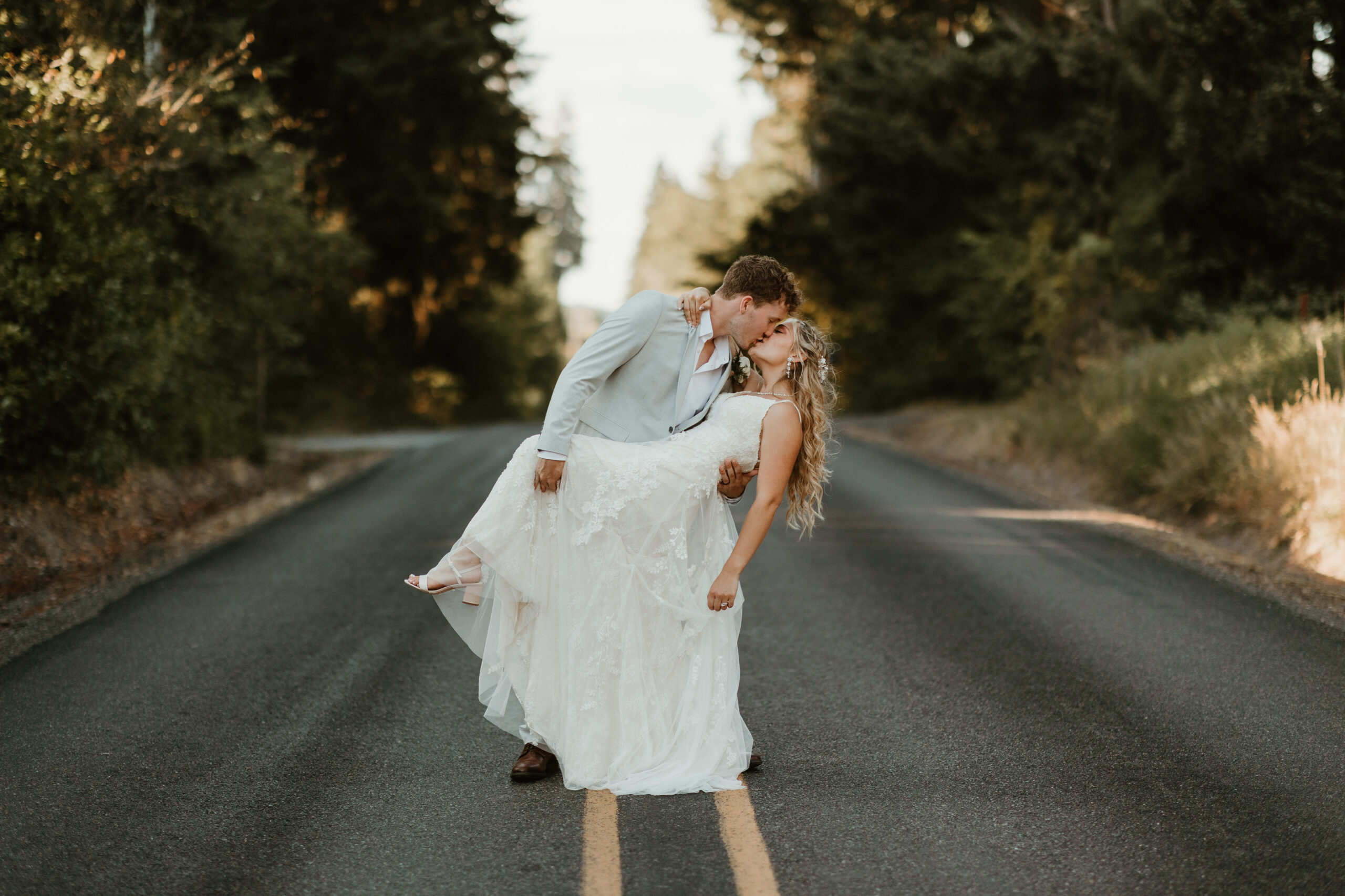 bride kissing her groom in the middle of the road in eatonville washington
