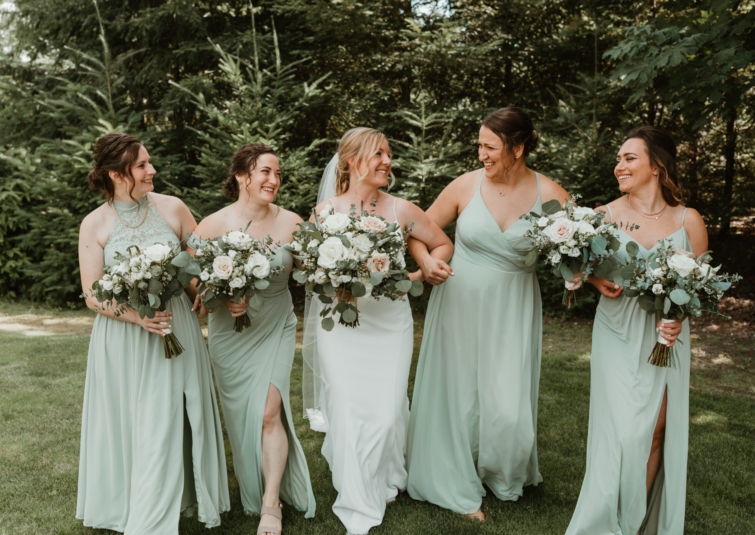 bride and her bridesmaids walking together and laughing