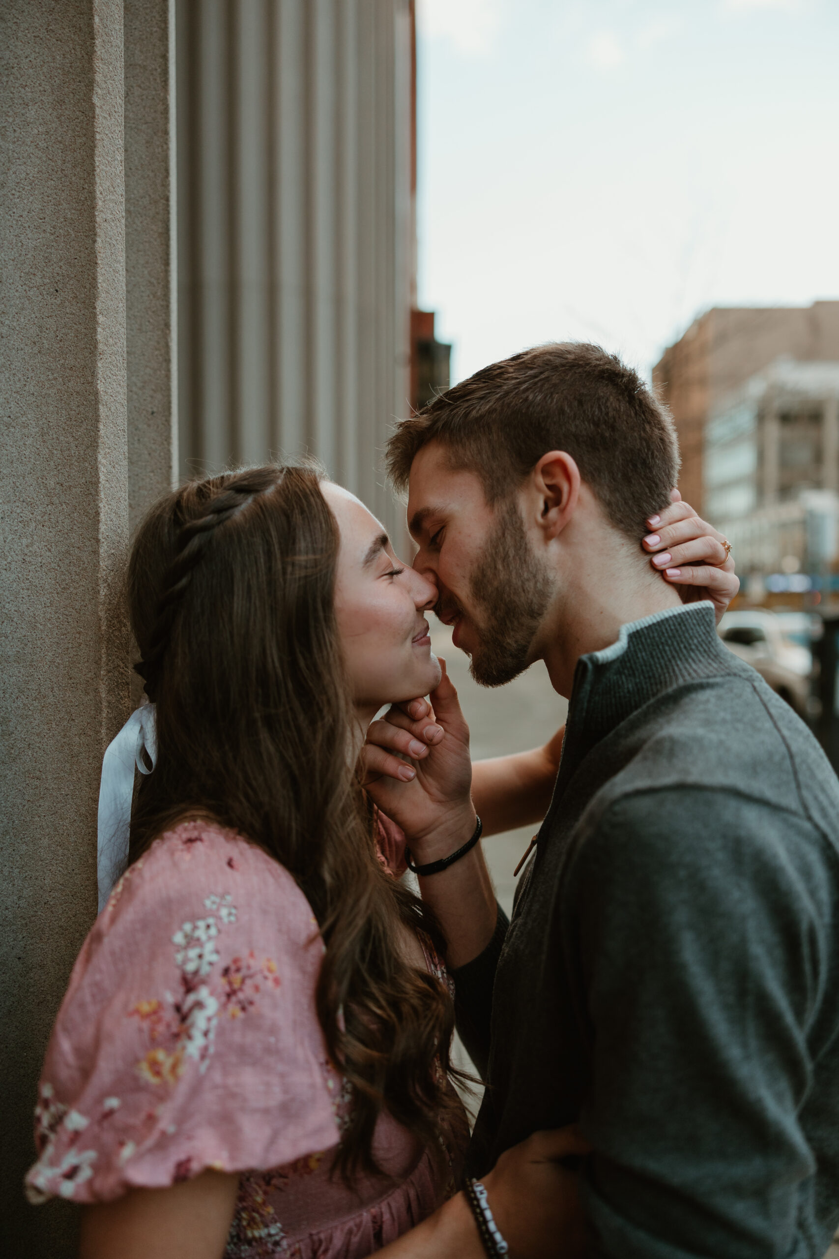 man and woman kissing in the city