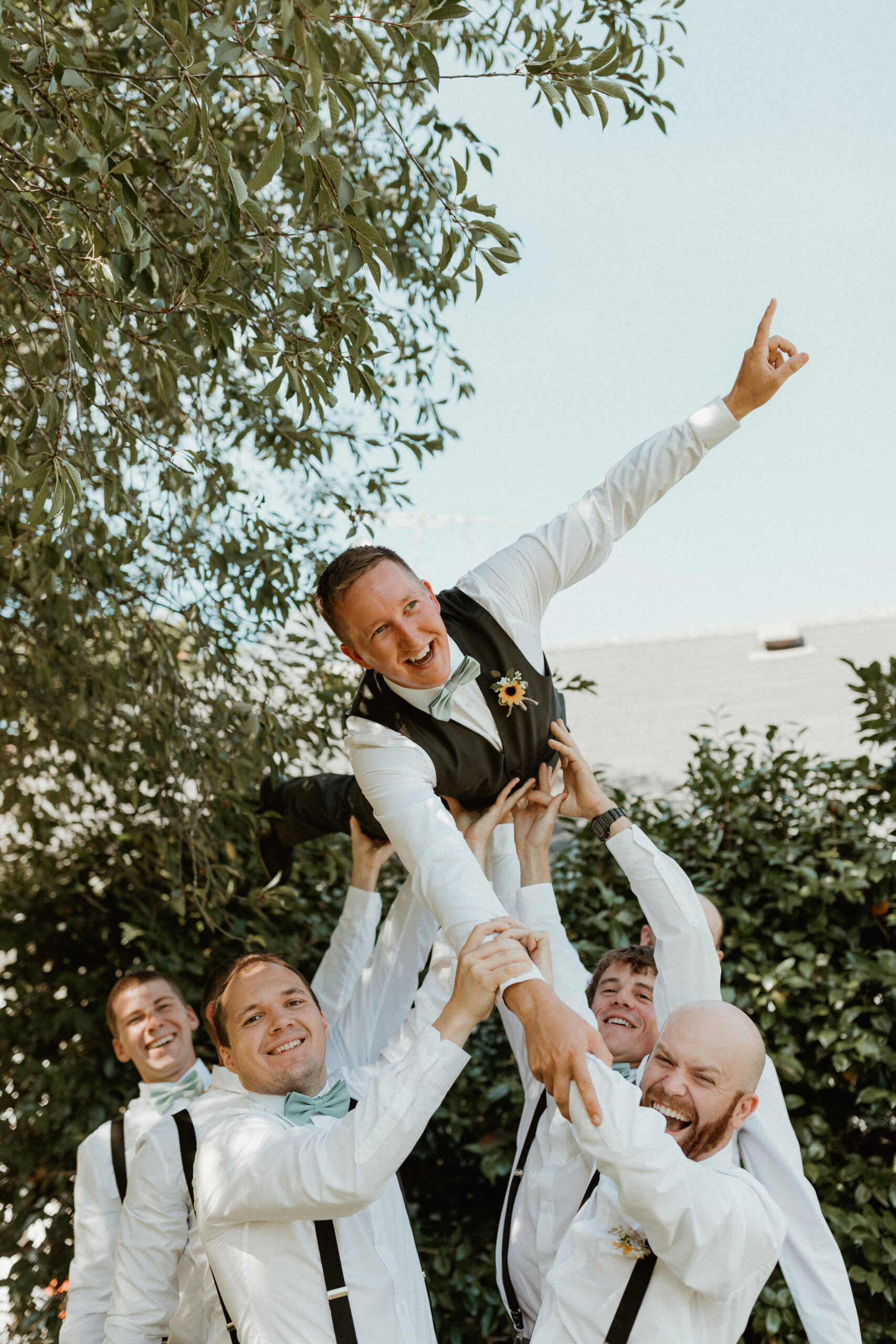 groomsmen throwing the groom in the air in Oregon